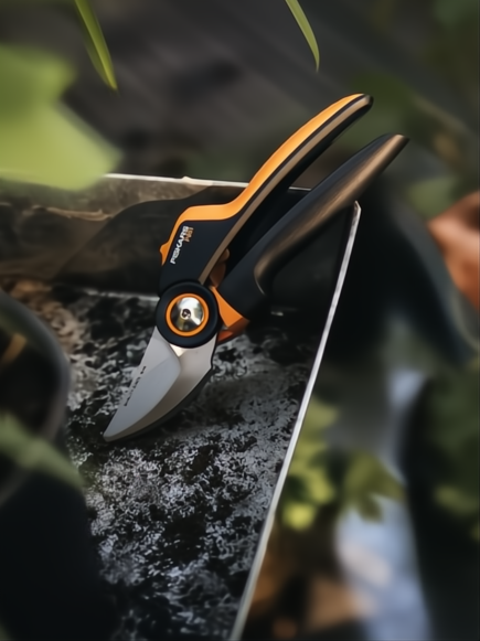 Tijera de podar Fiskars X-Series P961 negra y naranja con hoja de acero templado.