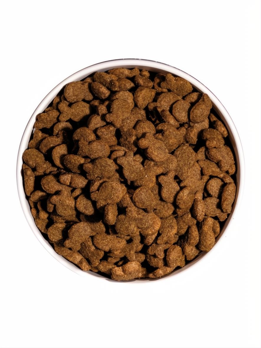 OWNAT CLASSIC FISH 4 KG dog food kibble in a white bowl, top view.